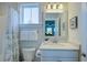 Well-lit bathroom boasts a neutral color scheme, decorative mirror, and combination shower and tub at 3522 Habenaria Rd, Mount Pleasant, SC 29466