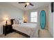 Comfortable bedroom features a surf board, plush carpet, and a soft queen-size bed with decorative pillows at 3522 Habenaria Rd, Mount Pleasant, SC 29466