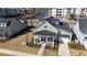 Charming green cottage with front porch, an American flag, and a manicured lawn with an attached garage at 3522 Habenaria Rd, Mount Pleasant, SC 29466