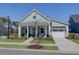 Charming home with a manicured front yard, inviting porch, and a two-car garage, showcasing curb appeal at 3522 Habenaria Rd, Mount Pleasant, SC 29466
