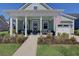 Inviting home featuring a charming front porch adorned with stylish decor and lush, manicured landscaping at 3522 Habenaria Rd, Mount Pleasant, SC 29466