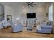 Comfortable living room features a ceiling fan, hardwood flooring, and light gray furnishings at 3522 Habenaria Rd, Mount Pleasant, SC 29466