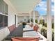 Inviting back porch featuring an outdoor dining table and lush landscaping at 3537 Sewel Ave, Mount Pleasant, SC 29466