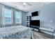 Bright bedroom with a comfortable bed, a modern entertainment center, and natural light from large windows at 3537 Sewel Ave, Mount Pleasant, SC 29466
