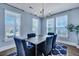 Bright dining room featuring a modern chandelier and large windows for abundant natural light at 3537 Sewel Ave, Mount Pleasant, SC 29466