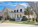 Inviting home with a charming front porch and beautifully landscaped yard at 3537 Sewel Ave, Mount Pleasant, SC 29466