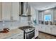 Modern kitchen showcasing white cabinets, a stainless steel range hood, and light countertops at 3537 Sewel Ave, Mount Pleasant, SC 29466