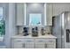 Eat-in kitchen features stainless steel refrigerator and appliances, granite countertops and white cabinets at 3537 Sewel Ave, Mount Pleasant, SC 29466