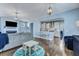 Open-concept living room flowing into a modern kitchen with hardwood floors and stylish lighting at 3537 Sewel Ave, Mount Pleasant, SC 29466