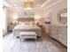 Comfortable and stylish main bedroom with neutral tones, tray ceiling, shiplap accent wall, and ensuite bathroom at 4004 Flatiron Dr, Charleston, SC 29414
