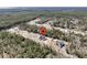 An aerial view shows a new home surrounded by woods and another home with a pool nearby at 4036 Azalea Farms Way, McClellanville, SC 29458