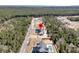 Aerial view featuring red pin over house in a forest setting with coastline in distance at 4036 Azalea Farms Way, McClellanville, SC 29458