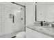 A stylish bathroom features a glass enclosed shower with modern fixtures and a marble countertop at 4036 Azalea Farms Way, McClellanville, SC 29458