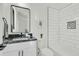 Modern bathroom featuring black marble countertops, stylish fixtures, and a shower with white subway tile at 4036 Azalea Farms Way, McClellanville, SC 29458