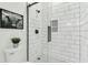 Modern shower with a rain shower head, white subway tiles, black accents, and geometric patterned tile at 4036 Azalea Farms Way, McClellanville, SC 29458