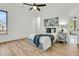Bright bedroom with hardwood floors, a ceiling fan, and large windows providing natural light at 4036 Azalea Farms Way, McClellanville, SC 29458