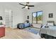 Inviting bedroom featuring two twin beds, hardwood floors, large windows and modern lighting at 4036 Azalea Farms Way, McClellanville, SC 29458
