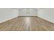 Large bonus room or flex space with light hardwood floors and a modern window at 4036 Azalea Farms Way, McClellanville, SC 29458