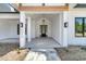 Welcoming entryway featuring a black front door and decorative lighting fixtures at 4036 Azalea Farms Way, McClellanville, SC 29458