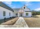 Charming exterior view of a modern farmhouse with a stone walkway and manicured landscaping at 4036 Azalea Farms Way, McClellanville, SC 29458