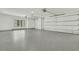 Spacious two car garage with a light colored epoxy floor and insulated garage doors at 4036 Azalea Farms Way, McClellanville, SC 29458