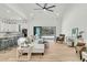 Open-concept living room with a white sofa, and a view of the kitchen and backyard at 4036 Azalea Farms Way, McClellanville, SC 29458
