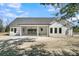 Rear of house featuring screened porch with ceiling fans and brick patio at 4036 Azalea Farms Way, McClellanville, SC 29458