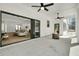 A covered patio features an outdoor fireplace, ceiling fans, and sliding glass doors that open to the living room at 4036 Azalea Farms Way, McClellanville, SC 29458