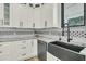Modern kitchen featuring a black sink and sleek white cabinetry at 4036 Azalea Farms Way, McClellanville, SC 29458