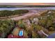 Expansive aerial view of the property featuring a pool, waterfront access, and mature landscaping at 4051 Colonel Vanderhorst Cir, Mount Pleasant, SC 29466