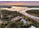 Stunning aerial perspective capturing the waterfront estate, showcasing its lush surroundings and serene ambiance at 4051 Colonel Vanderhorst Cir, Mount Pleasant, SC 29466