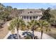 Aerial view of a home showcasing a front porch, surrounded by a circular driveway and verdant palm trees at 4051 Colonel Vanderhorst Cir, Mount Pleasant, SC 29466