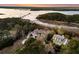 Breathtaking aerial view showcasing the home's waterfront location, sprawling grounds, and private dock at 4051 Colonel Vanderhorst Cir, Mount Pleasant, SC 29466