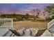 Spacious backyard with two lounge chairs on a wooden deck, overlooking scenic greenery and trees at 4051 Colonel Vanderhorst Cir, Mount Pleasant, SC 29466