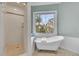Elegant bathroom featuring a clawfoot tub and a separate shower with a serene window view at 4051 Colonel Vanderhorst Cir, Mount Pleasant, SC 29466