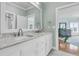 Well-lit bathroom with dual sinks and granite countertops, leading to a serene bedroom at 4051 Colonel Vanderhorst Cir, Mount Pleasant, SC 29466