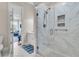Bright bathroom features tiled walk-in shower with glass door and adjacent view into furnished living room at 4051 Colonel Vanderhorst Cir, Mount Pleasant, SC 29466