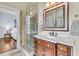 Bathroom with a marble-topped vanity, a decorative mirror, and a glass-enclosed tiled shower at 4051 Colonel Vanderhorst Cir, Mount Pleasant, SC 29466