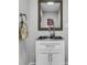 Small bathroom sink with a square mirror and chrome faucet, accented by a patterned towel and neutral wall color at 4051 Colonel Vanderhorst Cir, Mount Pleasant, SC 29466