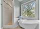 Elegant bathroom featuring a clawfoot tub and a separate shower with a serene window view at 4051 Colonel Vanderhorst Cir, Mount Pleasant, SC 29466