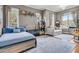 Cozy bedroom featuring a comfortable bed, a small white loveseat, and abundant natural light from multiple windows at 4051 Colonel Vanderhorst Cir, Mount Pleasant, SC 29466