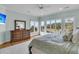 Spacious bedroom with windows overlooking the landscape, featuring a king-sized bed and dresser at 4051 Colonel Vanderhorst Cir, Mount Pleasant, SC 29466