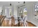Charming breakfast nook with a glass table and warm wood floors, adjacent to a hallway at 4051 Colonel Vanderhorst Cir, Mount Pleasant, SC 29466