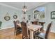 Elegant dining room with wood table, chandelier, and large window at 4051 Colonel Vanderhorst Cir, Mount Pleasant, SC 29466