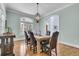 Elegant dining room with table, chandelier, and a large window at 4051 Colonel Vanderhorst Cir, Mount Pleasant, SC 29466