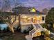Two-story home featuring a front porch with railings and a set of stairs leading to a lush, green yard at 4051 Colonel Vanderhorst Cir, Mount Pleasant, SC 29466