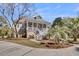 Charming home featuring a welcoming front porch, manicured landscaping, and a circular driveway at 4051 Colonel Vanderhorst Cir, Mount Pleasant, SC 29466