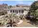A home with a welcoming porch, complemented by mature trees and manicured landscaping, offers classic charm at 4051 Colonel Vanderhorst Cir, Mount Pleasant, SC 29466