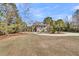 A home sits back from the street with a manicured lawn and circular drive leading to the entrance and front porch at 4051 Colonel Vanderhorst Cir, Mount Pleasant, SC 29466