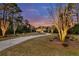 A long driveway leading to a grand home, set amidst beautifully landscaped grounds and mature trees at 4051 Colonel Vanderhorst Cir, Mount Pleasant, SC 29466